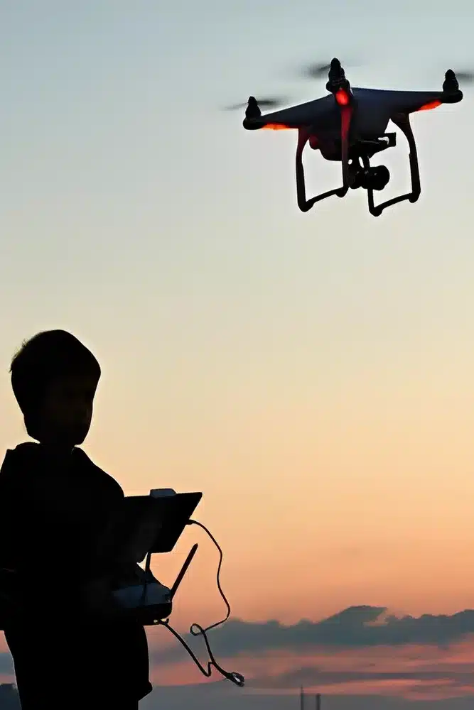 A boy flying a drone